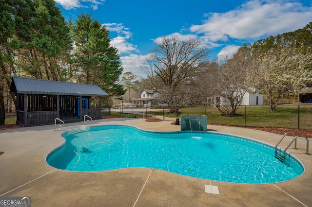 view of swimming pool with a patio, an outbuilding, a fenced in pool, and fence
