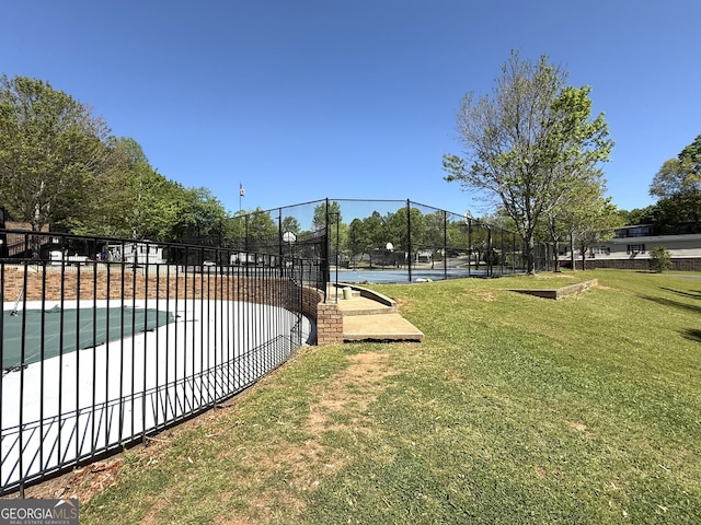view of community featuring a yard, fence, and a pool