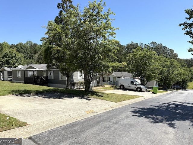 750 Six Flags Rd Lot 417, Austell, GA 30168 - view of property hidden behind natural elements featuring a residential view and a front lawn