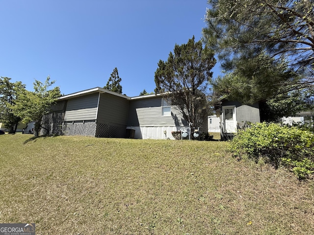 view of home's exterior with a yard