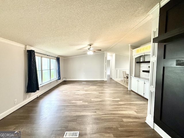 750 Six Flags Rd Lot 417, Austell, GA 30168 - unfurnished living room featuring ornamental molding, ceiling fan, a textured ceiling, wood finished floors, and baseboards