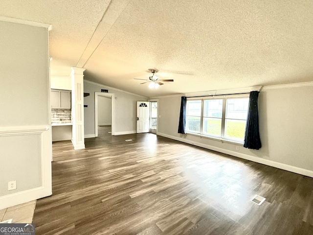 750 Six Flags Rd Lot 417, Austell, GA 30168 - unfurnished living room with ceiling fan, crown molding, a textured ceiling, dark wood-style floors, and baseboards