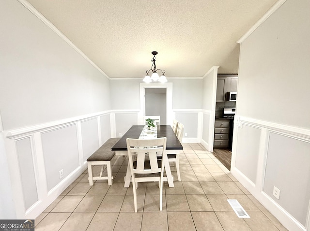 750 Six Flags Rd Lot 417, Austell, GA 30168 - dining area featuring a decorative wall, crown molding, a chandelier, light tile patterned flooring, and wainscoting