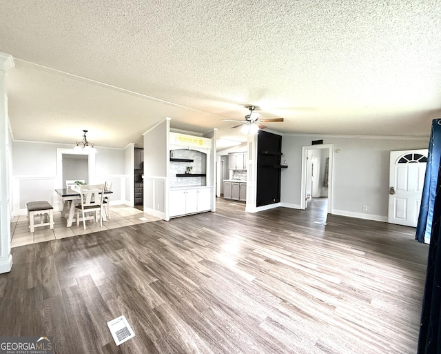750 Six Flags Rd Lot 417, Austell, GA 30168 - unfurnished living room featuring a ceiling fan, a textured ceiling, wood finished floors, a chandelier, and ornamental molding