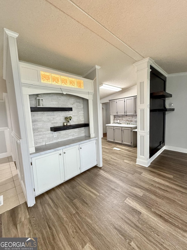 750 Six Flags Rd Lot 417, Austell, GA 30168 - bar with dark wood-type flooring, a textured ceiling, baseboards, crown molding, and backsplash