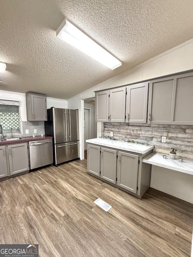 750 Six Flags Rd Lot 417, Austell, GA 30168 - kitchen with appliances with stainless steel finishes, gray cabinets, a textured ceiling, a sink, and tasteful backsplash