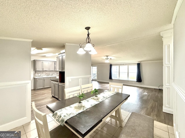 750 Six Flags Rd Lot 417, Austell, GA 30168 - dining area featuring a textured ceiling, a ceiling fan, light tile patterned floors, ornamental molding, and wainscoting
