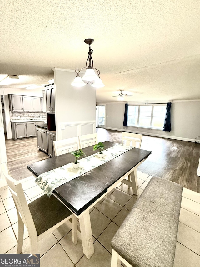 750 Six Flags Rd Lot 417, Austell, GA 30168 - dining room featuring a textured ceiling, a ceiling fan, light tile patterned floors, and a chandelier