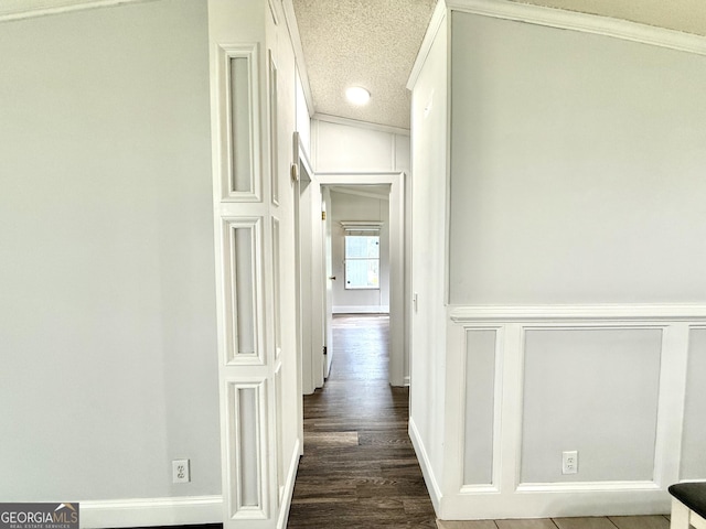750 Six Flags Rd Lot 417, Austell, GA 30168 - hall featuring a decorative wall, crown molding, a textured ceiling, dark wood-style floors, and baseboards