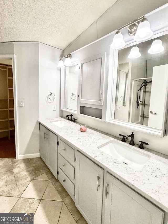 750 Six Flags Rd Lot 417, Austell, GA 30168 - full bathroom with double vanity, a textured ceiling, baseboards, and tile patterned floors