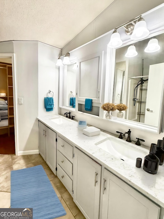 750 Six Flags Rd Lot 417, Austell, GA 30168 - bathroom with double vanity, tile patterned floors, a textured ceiling, and vaulted ceiling