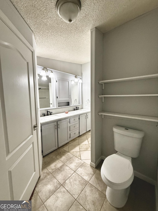 750 Six Flags Rd Lot 417, Austell, GA 30168 - full bath featuring double vanity, toilet, tile patterned floors, a textured ceiling, and baseboards