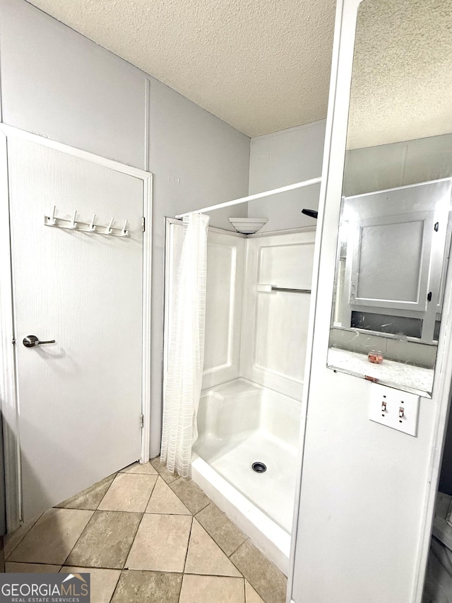 750 Six Flags Rd Lot 417, Austell, GA 30168 - bathroom featuring a shower stall, a textured ceiling, and tile patterned flooring