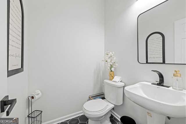 112 Timber Mist Ln, Lawrenceville, GA 30045 - half bathroom featuring tile patterned flooring, baseboards, a sink, and toilet