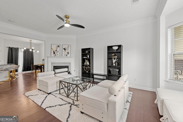 112 Timber Mist Ln, Lawrenceville, GA 30045 - living room with baseboards, a fireplace, crown molding, wood finished floors, and ceiling fan with notable chandelier