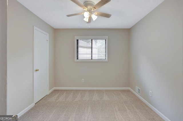 unfurnished room with ceiling fan, baseboards, visible vents, and carpet floors