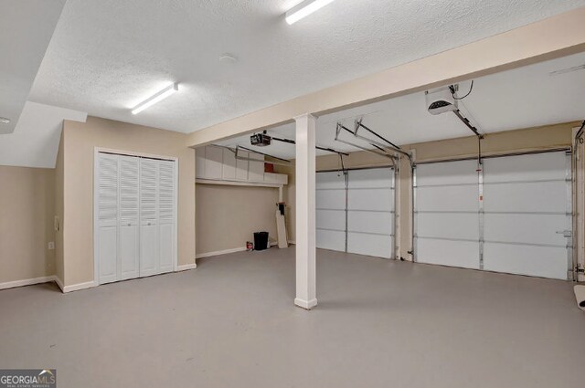 garage featuring baseboards and a garage door opener