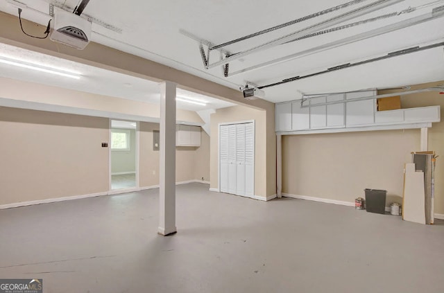 garage featuring baseboards and a garage door opener