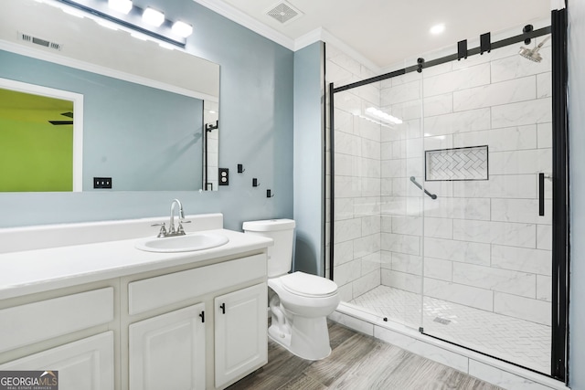 bathroom with ornamental molding, a stall shower, toilet, and visible vents