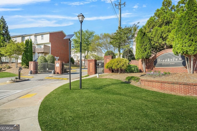surrounding community featuring a lawn and a gate