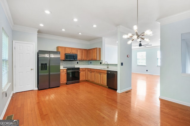 kitchen with black electric range, a sink, stainless steel fridge with ice dispenser, a chandelier, and dishwashing machine