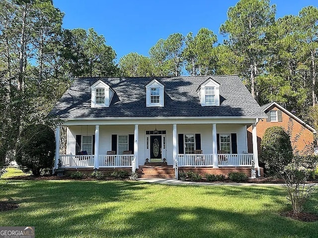 135 Southlake Dr, Moultrie, GA 31768 - new england style home featuring a porch, a front lawn, and roof with shingles