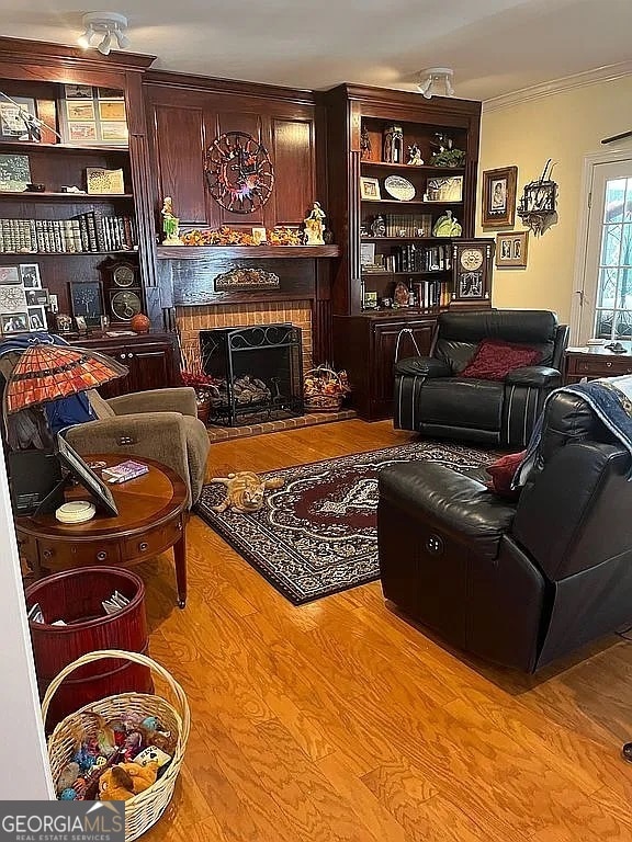 135 Southlake Dr, Moultrie, GA 31768 - living area with ornamental molding, a fireplace, and wood finished floors
