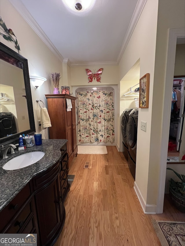 135 Southlake Dr, Moultrie, GA 31768 - bathroom featuring wood finished floors, ornamental molding, vanity, and independent washer and dryer