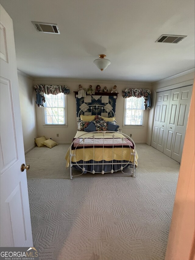135 Southlake Dr, Moultrie, GA 31768 - carpeted bedroom with multiple windows, baseboards, a closet, and crown molding