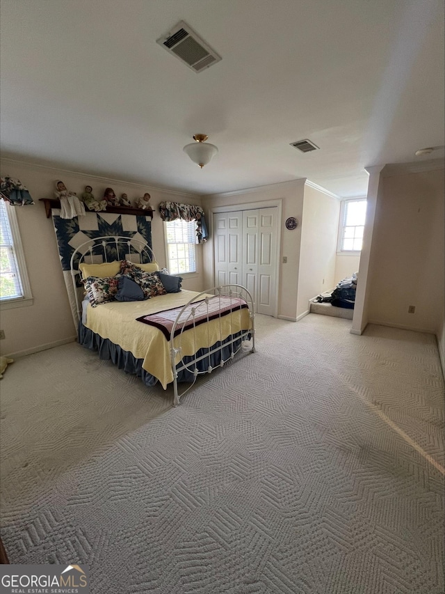 135 Southlake Dr, Moultrie, GA 31768 - carpeted bedroom featuring crown molding, multiple windows, baseboards, and a closet