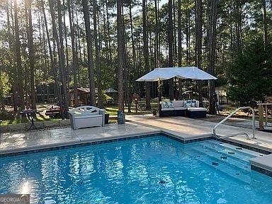 135 Southlake Dr, Moultrie, GA 31768 - outdoor pool featuring a patio and an outdoor hangout area