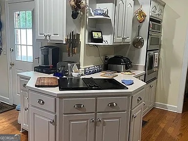 135 Southlake Dr, Moultrie, GA 31768 - kitchen with dark wood finished floors, light countertops, and baseboards