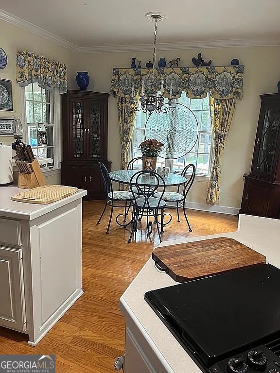 135 Southlake Dr, Moultrie, GA 31768 - dining area featuring crown molding, light wood-style floors, and a chandelier