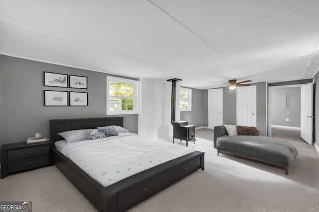carpeted bedroom featuring ceiling fan and baseboards