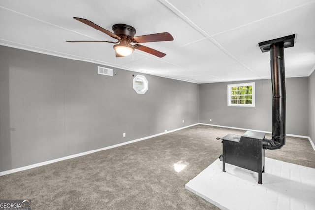unfurnished living room with a ceiling fan, carpet, and baseboards