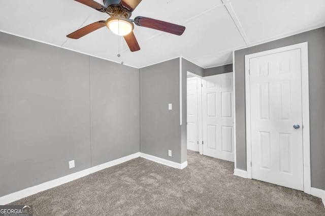 unfurnished bedroom with carpet, baseboards, and a ceiling fan