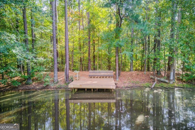 view of dock with a forest view