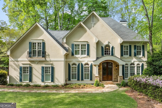 6140 Rachel Rdg, Peachtree Corners, GA 30092 - view of front facade featuring french doors, stucco siding, a chimney, a shingled roof, and a front yard