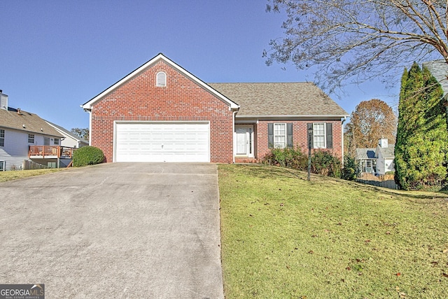 view of front of house with roof with shingles, a front yard, brick siding, an attached garage, and concrete driveway