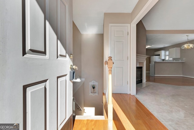 entrance foyer with a fireplace with flush hearth, wood finished floors, and baseboards