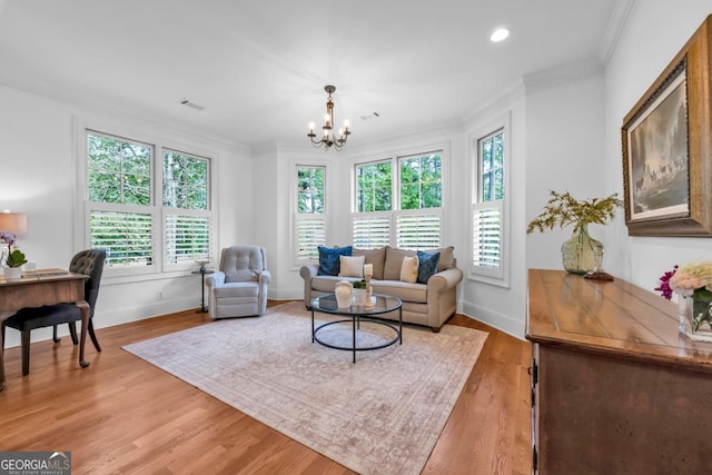 1021 Homestead, Greensboro, GA 30642 - living area with plenty of natural light, crown molding, a chandelier, light wood finished floors, and baseboards