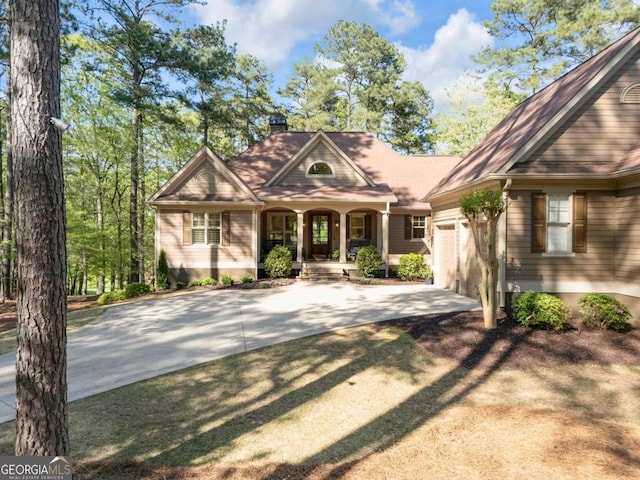 1021 Homestead, Greensboro, GA 30642 - view of front facade with concrete driveway, covered porch, a chimney, and an attached garage