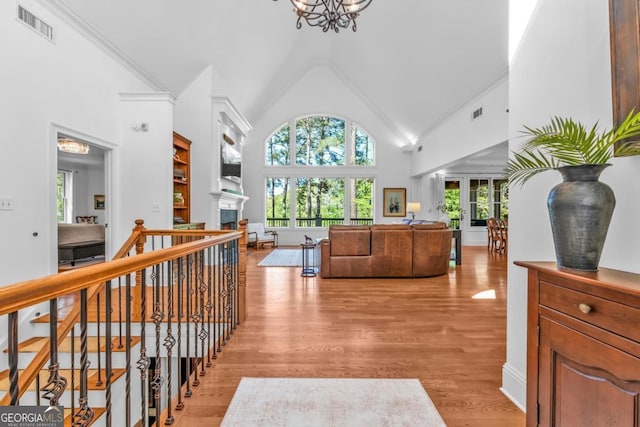 1021 Homestead, Greensboro, GA 30642 - corridor featuring high vaulted ceiling, a chandelier, and light wood-style flooring