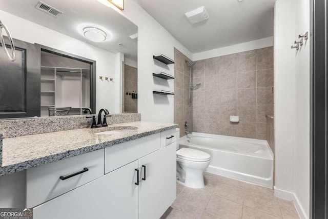 full bath with vanity, tile patterned floors, toilet, visible vents, and bathtub / shower combination