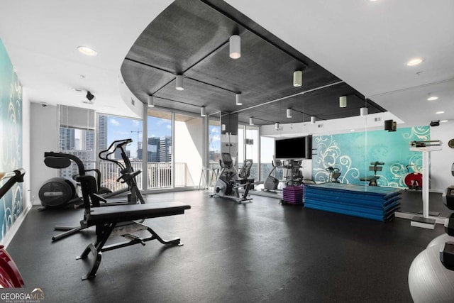 exercise room with floor to ceiling windows, a wealth of natural light, and recessed lighting