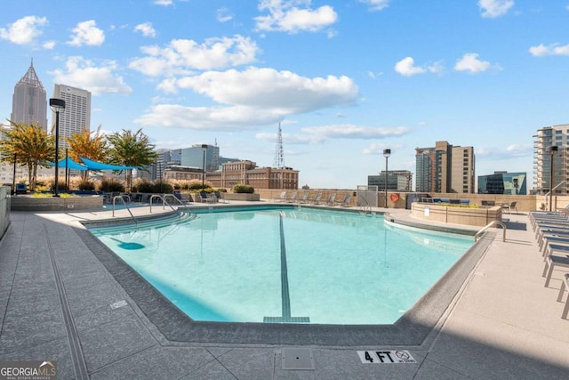 pool with a patio and a city view