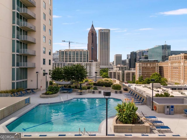 view of pool with a patio area and a city view