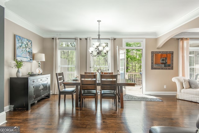 dining area with a chandelier, arched walkways, a healthy amount of sunlight, and ornamental molding