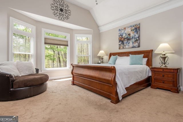 bedroom with ornamental molding, lofted ceiling, and carpet