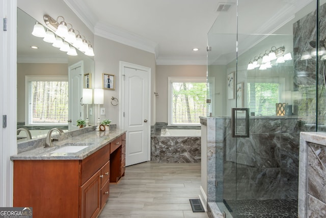bathroom with a bath, a stall shower, vanity, and visible vents